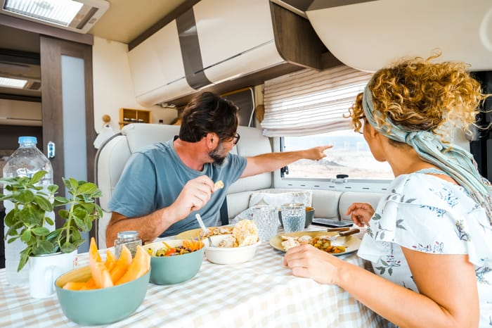 a-happy-couple-spending-time-together-having-fun-dinner-in-an-rv